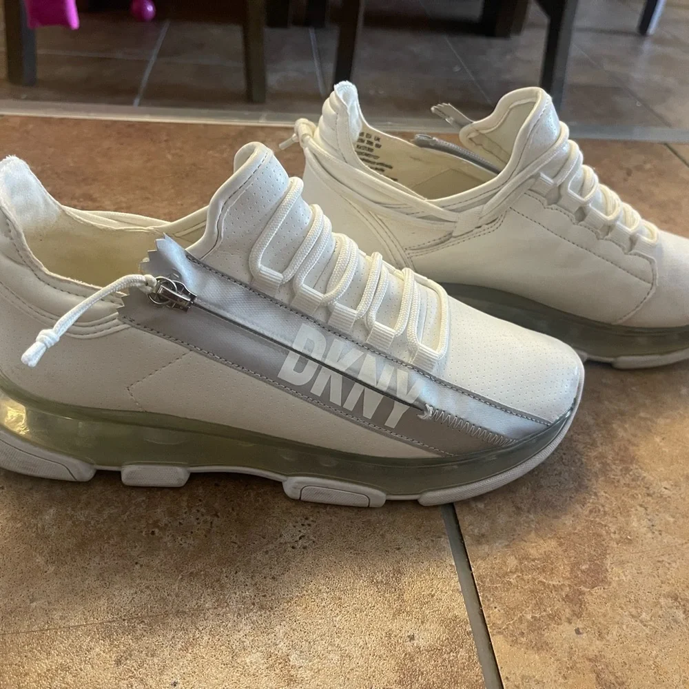 DKNY Women's White Slip-On Sneakers with Silver Logo Accent